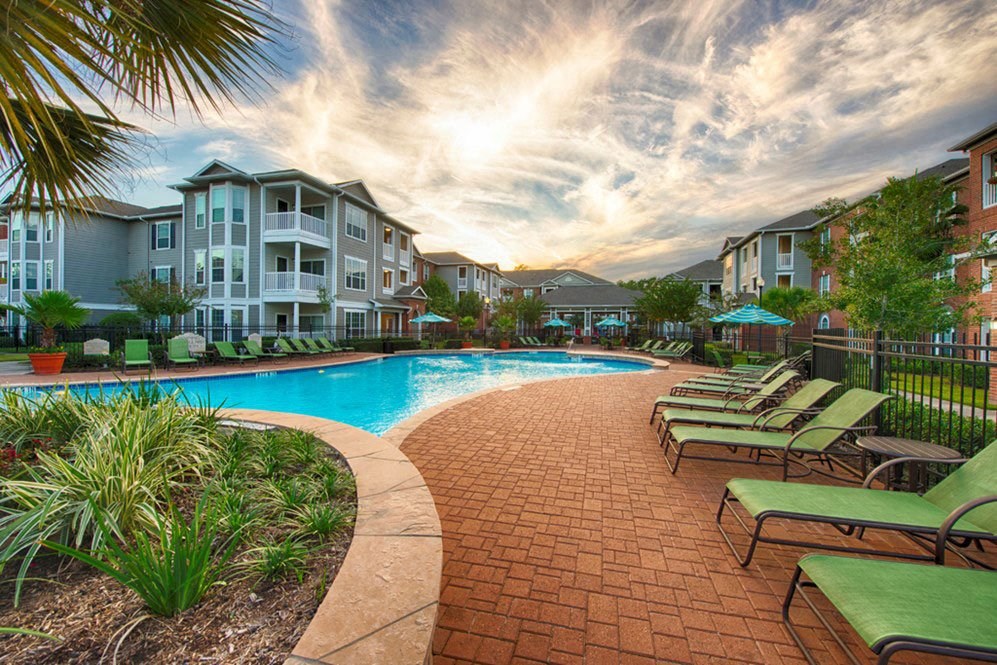 a swimming pool in front of an apartment building