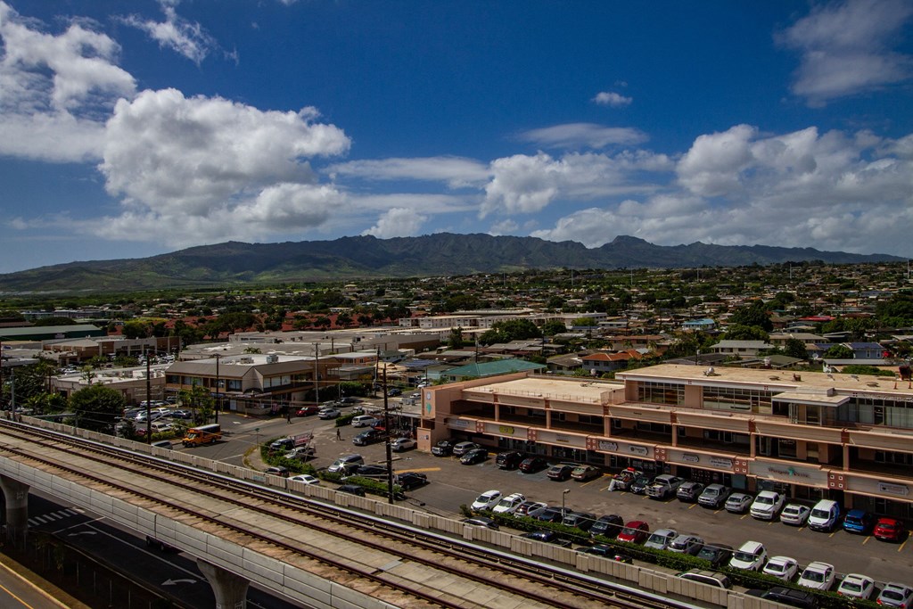 an aerial view of a city with train tracks and a building at Waikele Towers Apartments, Waipahu, HI 96797