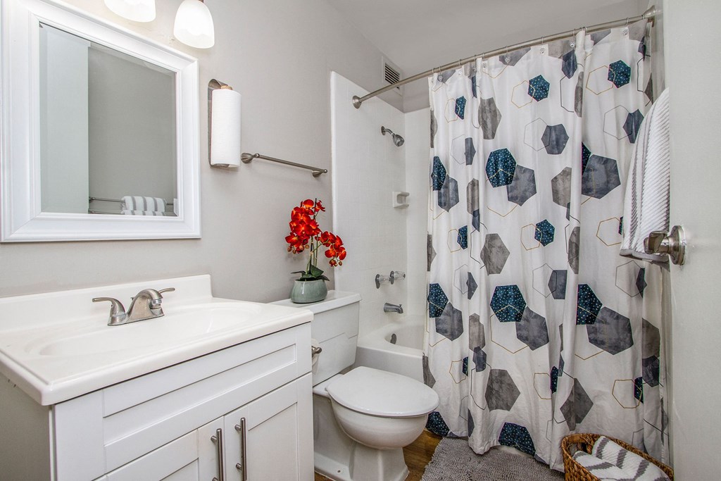 a bathroom with a shower curtain and a sink and a toilet at Waikele Towers Apartments, Hawaii, 96797