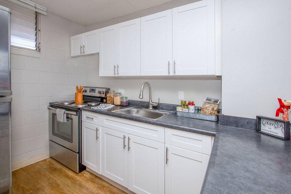a kitchen with white cabinets and stainless steel appliances and a sink at Waikele Towers Apartments, Waipahu, Hawaii