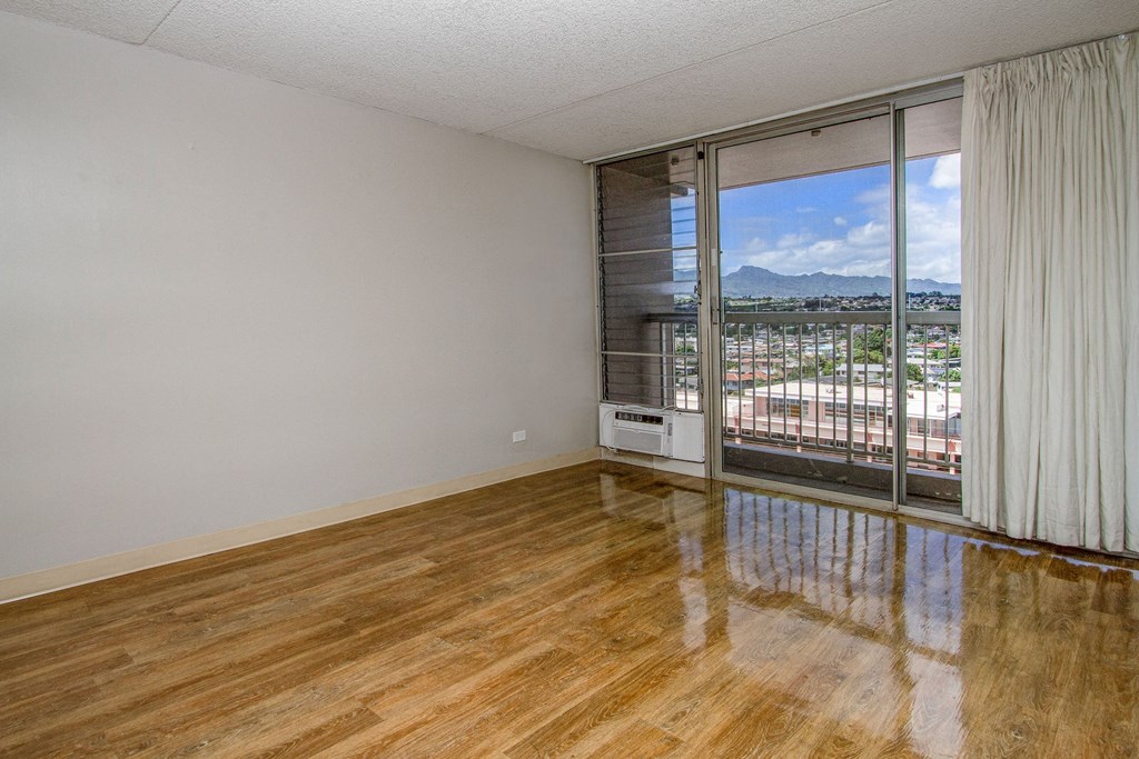 the living room of an apartment with a view of the city at Waikele Towers Apartments, Hawaii