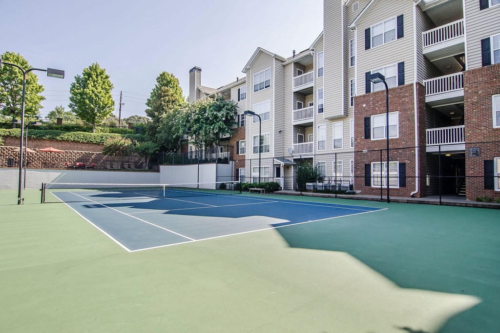 a tennis court in front of an apartment building at Willowest in Collier Hills, Atlanta, GA