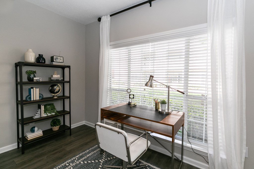 a home office with a large window with white blinds and a desk and chair a home office with a large window with white blinds and a desk and chair at Willowest in Collier Hills, Atlanta, Georgia