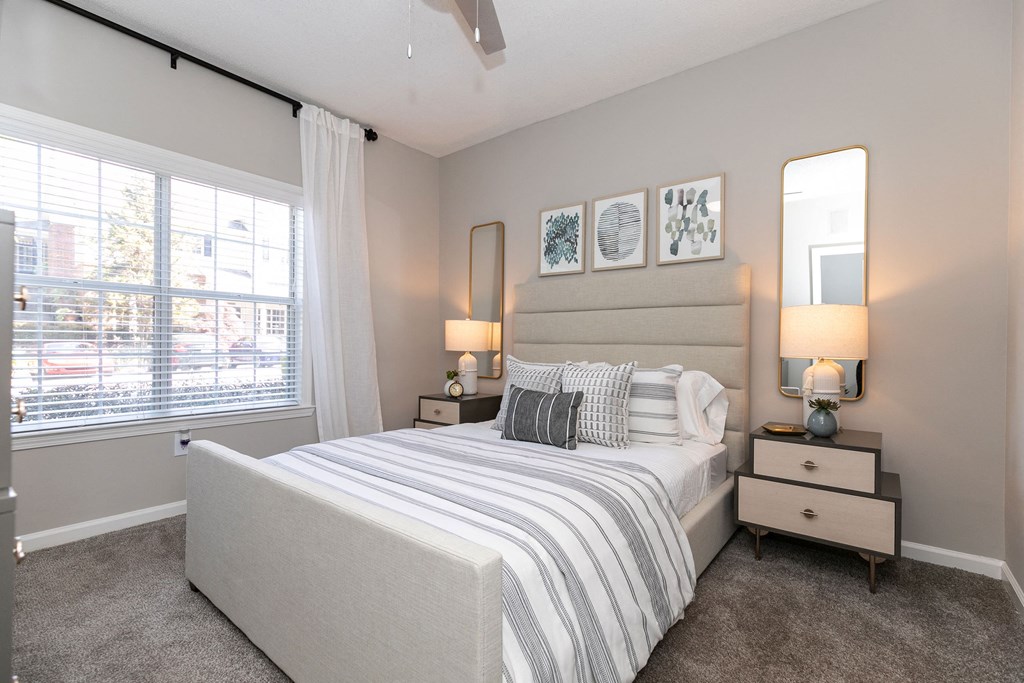 a bedroom with a bed and a large window a bedroom with a bed and a large window at Willowest in Collier Hills, Georgia, 30318