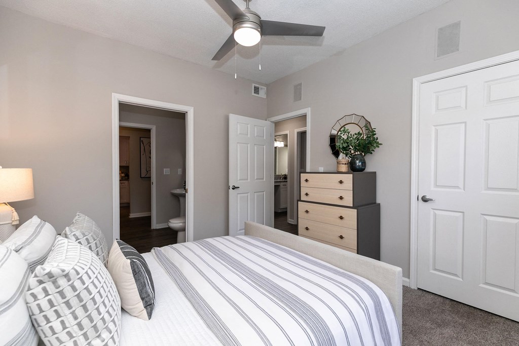a bedroom with a bed and a dresser and a ceiling fan a bedroom with a bed and a dresser and a ceiling fan at Willowest in Collier Hills, Atlanta, GA