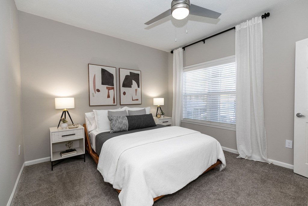 a bedroom with a bed and a ceiling fan a bedroom with a bed and a ceiling fan at Willowest in Collier Hills, Georgia