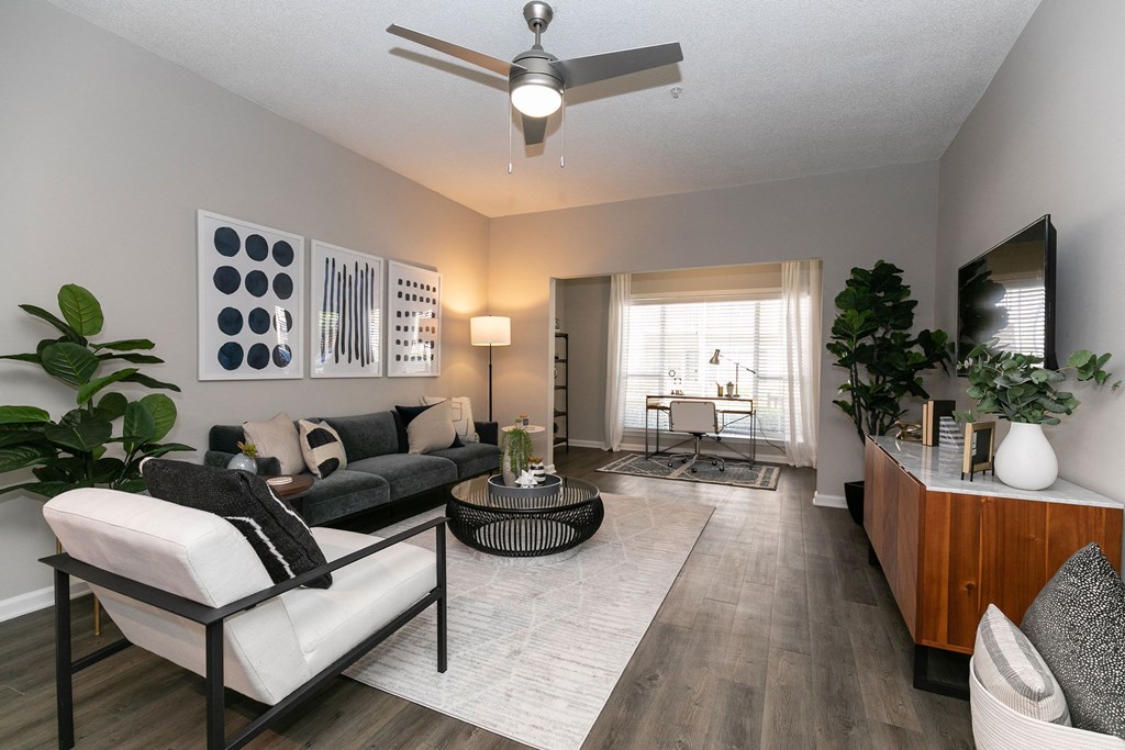 an open living room with a ceiling fan and an open living room with a ceiling fan and at Willowest in Collier Hills, Atlanta, GA