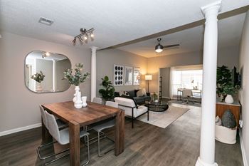 a dining room and living room with a table and chairs at Willowest in Collier Hills, Georgia, 30318