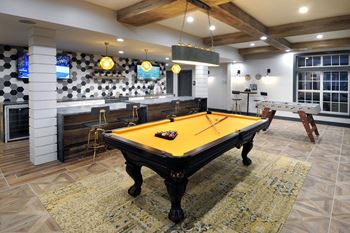 a pool table in a party room with a bar and televisions at Willowest in Lindbergh, Georgia, 30318