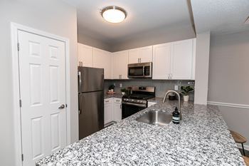 an expansive kitchen with granite counter tops and stainless steel appliances at Willowest in Lindbergh, Atlanta, GA, 30318