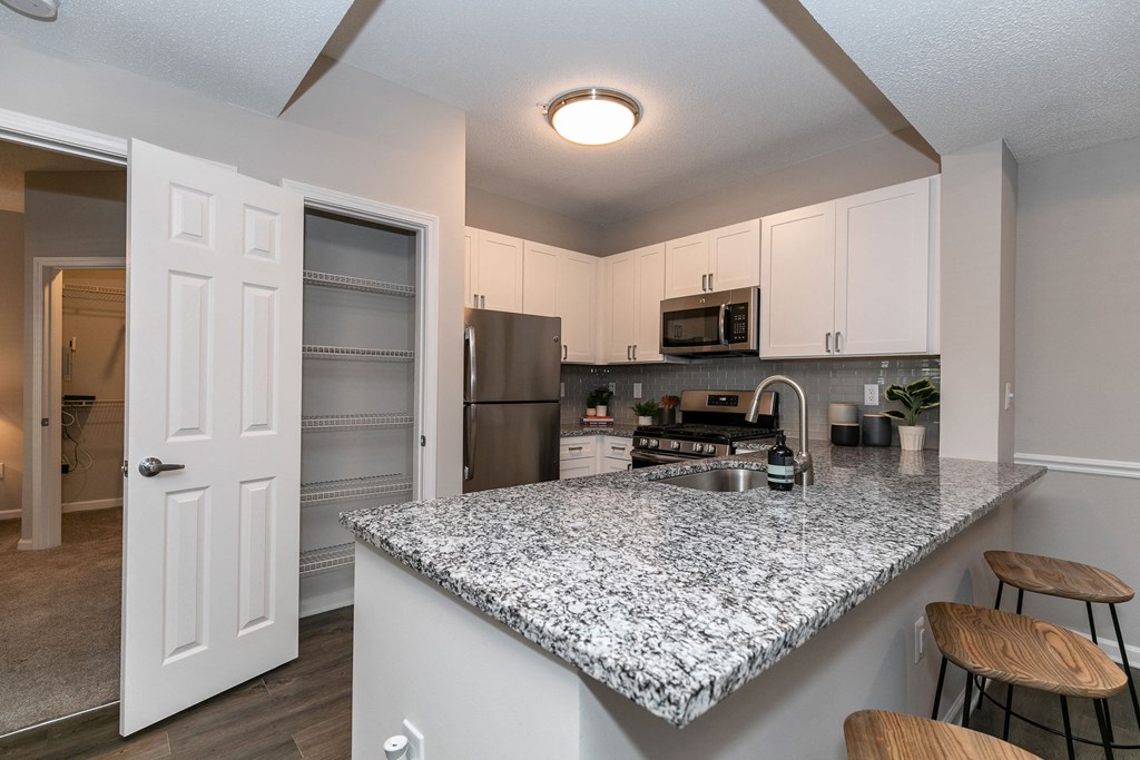 an open kitchen with a marble counter top an open kitchen with a marble counter top at Willowest in Lindbergh, Georgia