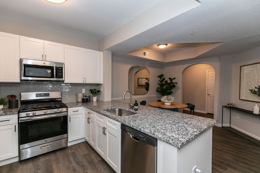 a kitchen with granite counter tops and stainless steel appliances a kitchen with granite counter tops and stainless steel appliances at Willowest in Lindbergh, Atlanta, GA, 30318