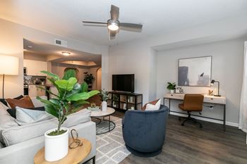 an open living room with a couch and a table with a plant at Willowest in Lindbergh, Atlanta, GA, 30318