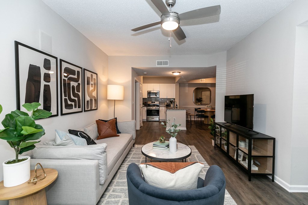 an open living room and kitchen with a ceiling fan an open living room and kitchen with a ceiling fan at Willowest in Lindbergh, Atlanta