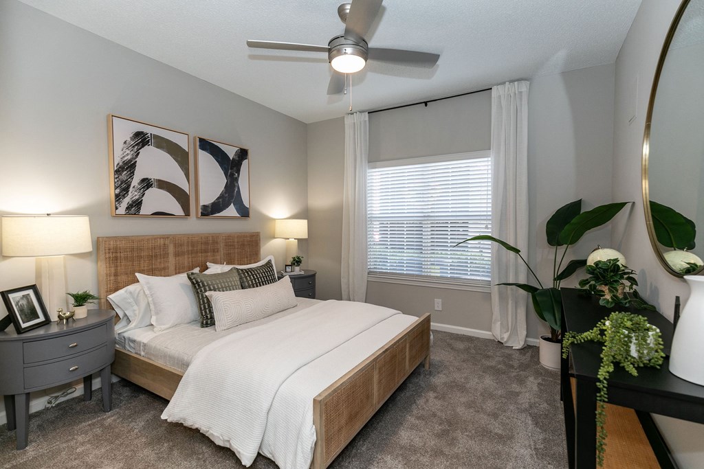 a bedroom with a large bed and a ceiling fan a bedroom with a large bed and a ceiling fan at Willowest in Lindbergh, Georgia