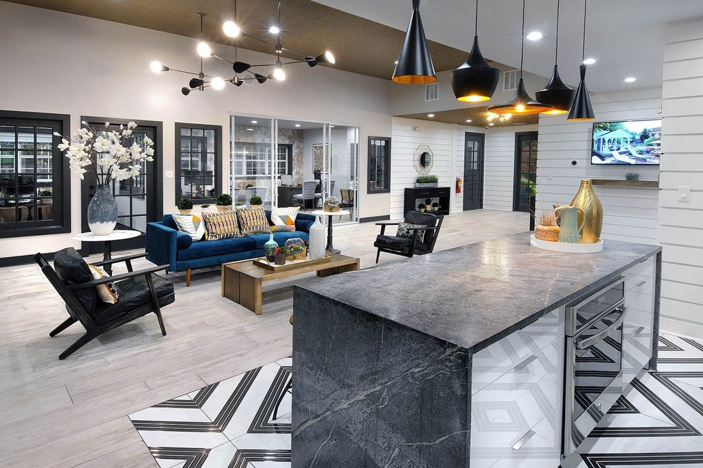 a large living room with a kitchen and a fireplace