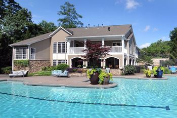 a large swimming pool in front of a house