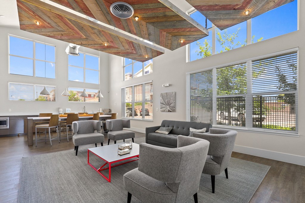 a room with a row of pictures on the wall and chairs and a table at Ridge at Thornton Station Apartments, Thornton