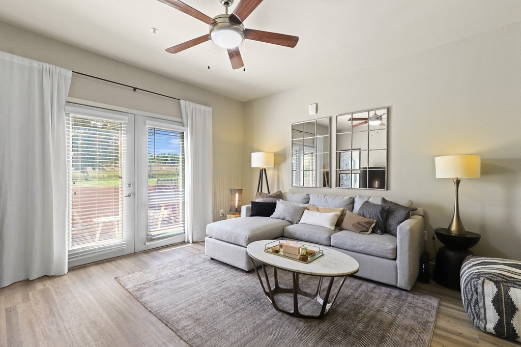 a living room with a couch and a ceiling fan at Apartments at Ridge at Thornton Station Apartments, Thornton, CO 80229