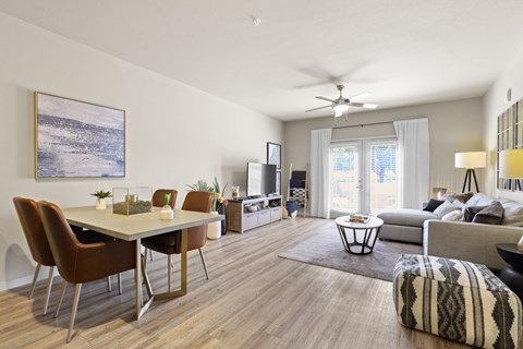 an open living room and dining room with a table and chairs at Ridge at Thornton Station Apartments, Thornton, CO 80229