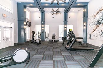 a gym with cardio equipment and a ceiling fan at Roswell Village, Roswell, Georgia