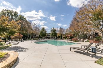 pool and spa with trees and chairs around it at Roswell Village, Roswell