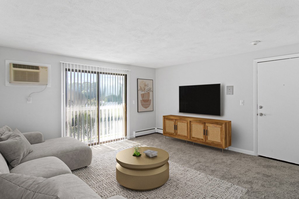 a living room with a gray couch and a tv  at Rosemont Square, Massachusetts