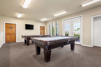 a game room with two pool tables and a tv at Chevy Chase, Texas