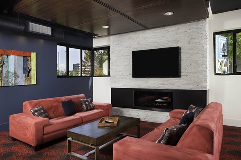 A living room with a fireplace and a television at Skye at Belltown Apartments, Seattle, WA