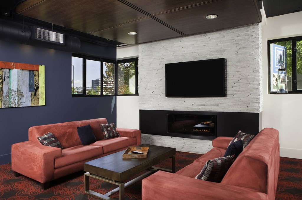 A living room with a fireplace and a television A living room with a fireplace and a television at Skye at Belltown Apartments, Seattle, WA