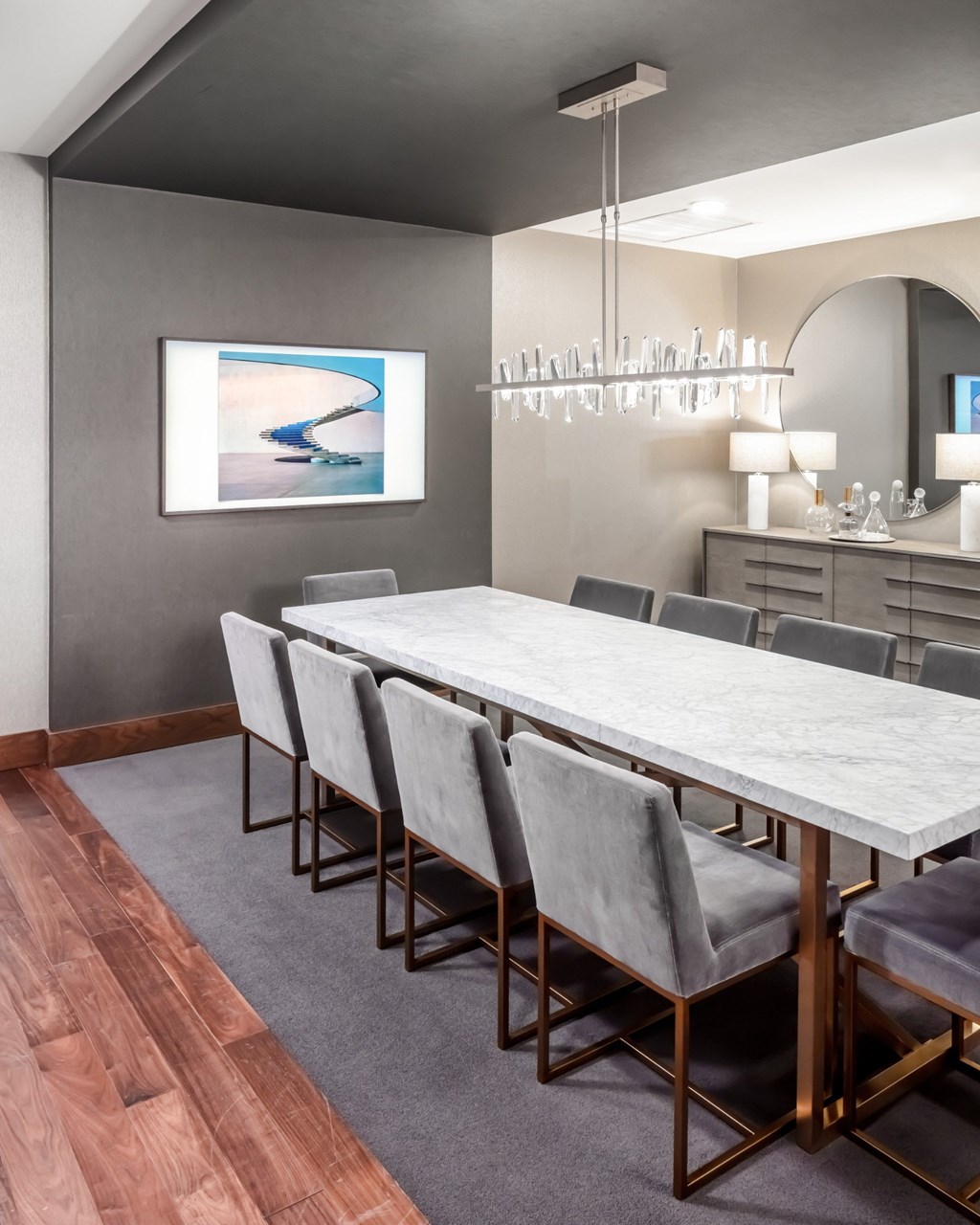 Modern dining room with a long table and grey chairs at 365 Nicollet, Minneapolis, Manchester