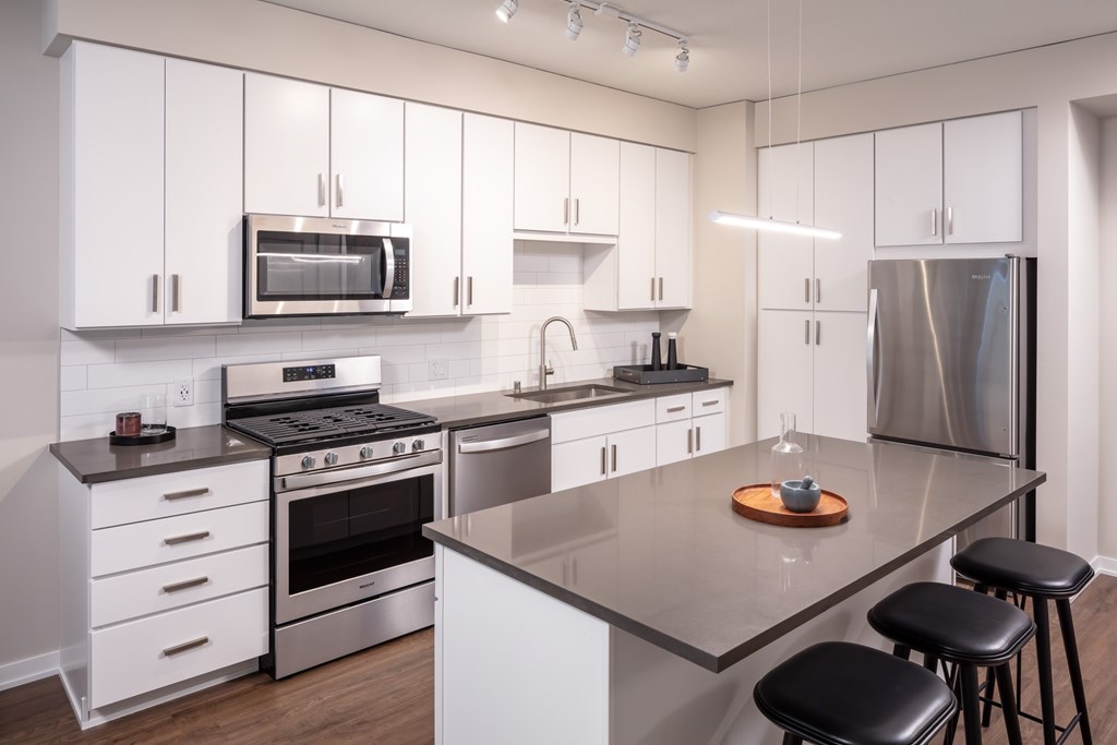A modern kitchen with white cabinets and stainless steel appliances at 365 Nicollet, Minneapolis, MN