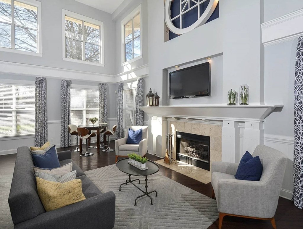 a living room with a fireplace and a tv above it