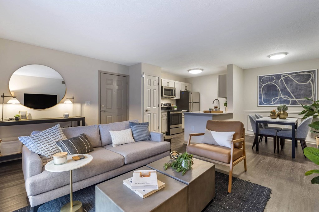 a living room with a couch and a table and a kitchen at Roswell Village, Roswell, GA