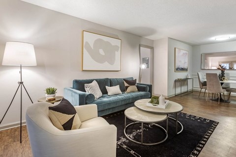 a living room with a blue couch and a table