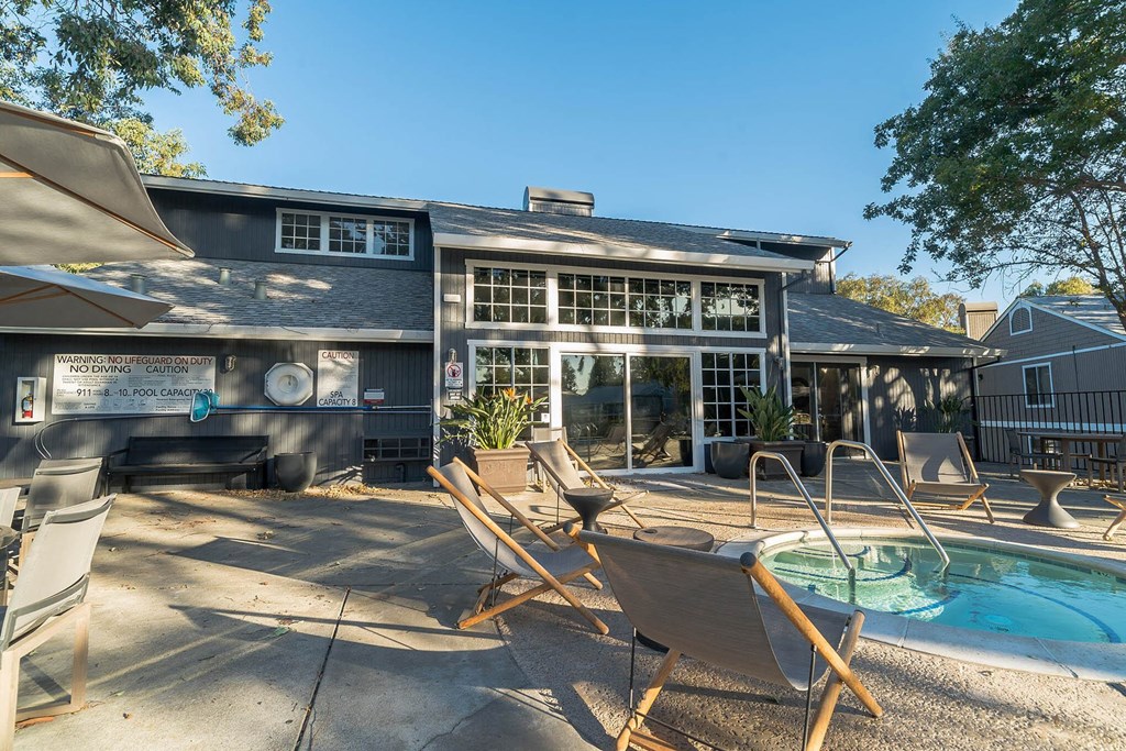 a patio with chairs and a pool in front of a house at Bay Village, Vallejo, 94590