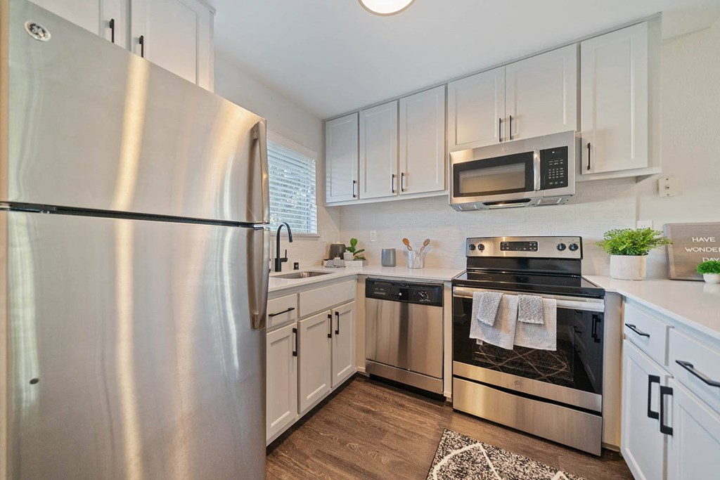 a kitchen with stainless steel appliances and white cabinets at Bay Village, Vallejo, CA, 94590