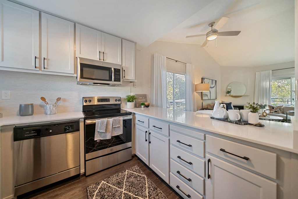 a kitchen with stainless steel appliances and white cabinets at Bay Village, Vallejo, 94590