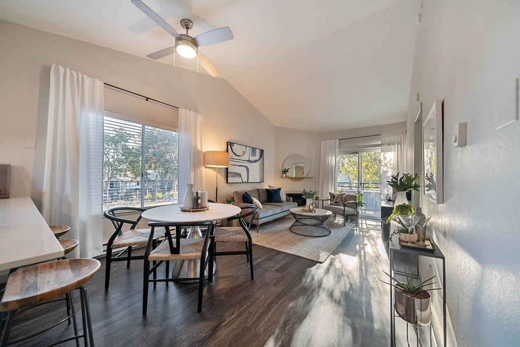 a living room with a table and a ceiling fan at Bay Village, Vallejo, California