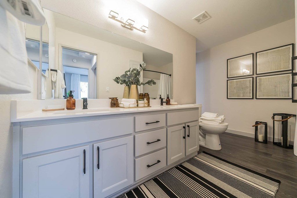 a bathroom with a sink and a toilet and a mirror at Bay Village, California, 94590