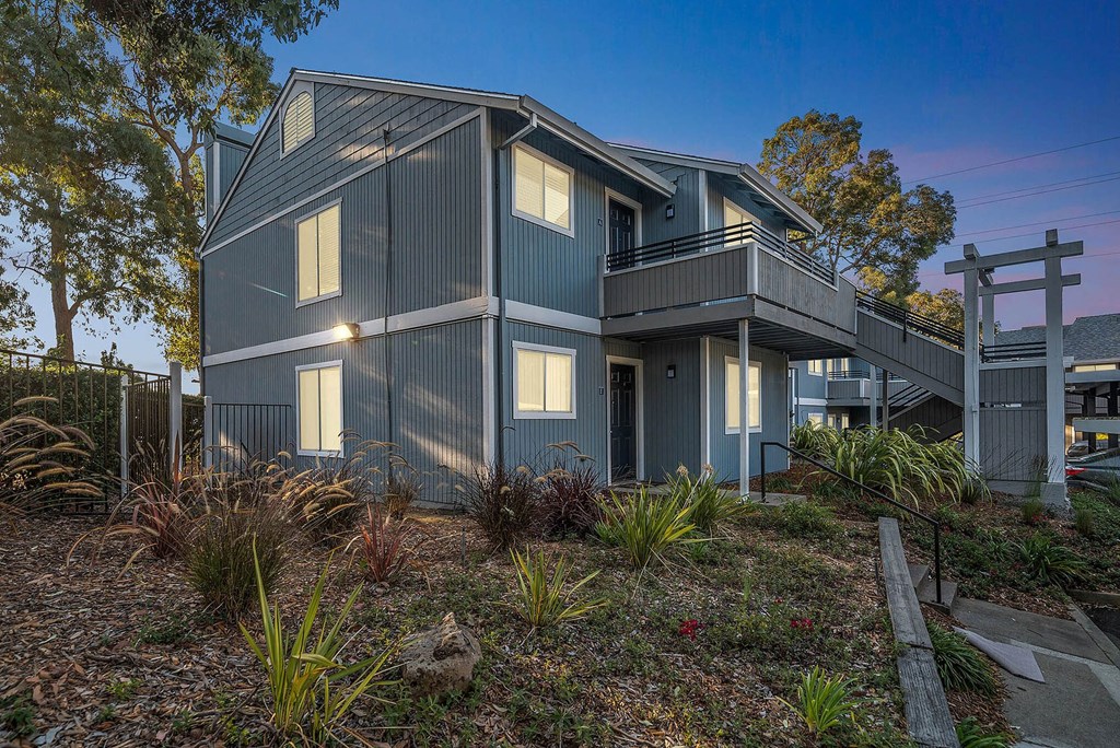 a blue house with a deck and a sunset at Bay Village, Vallejo, 94590