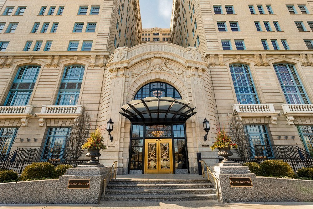 a large building with a golden door and stairs in front of it  at The Belden Stratford, Chicago, IL