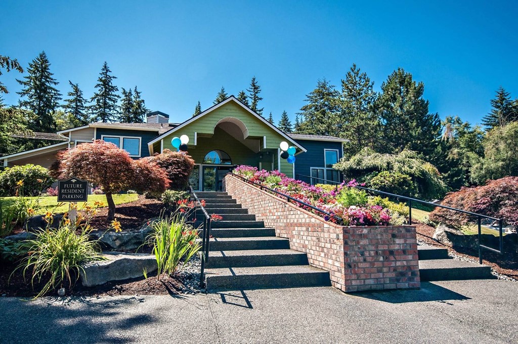 Entryway into the community with stone stairs and future resident parking at Brackett Apartments, Washington