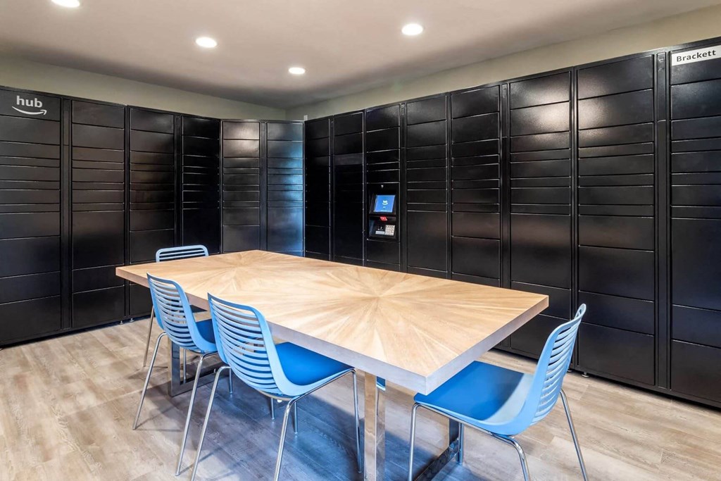 A conference room with a wooden table and blue chairs at Brackett Apartments, Washington