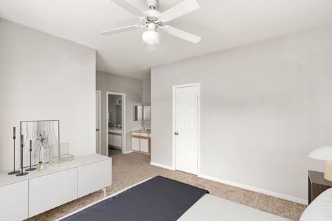 a bedroom with a bed and a ceiling fan at Veranda at Centerfield, Houston, 77070
