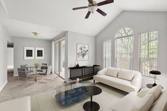 a living room with white furniture and a ceiling fan at Veranda at Centerfield, Houston, 77070