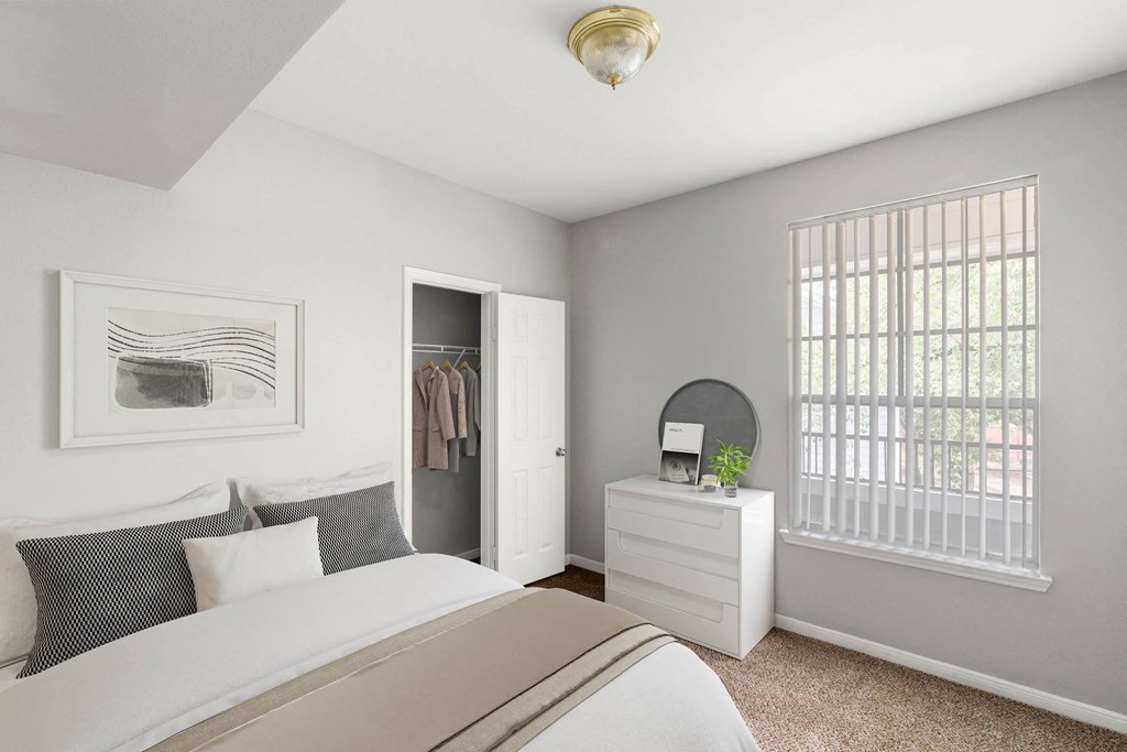 a bedroom with a bed and a closet at Veranda at Centerfield, Texas, 77070