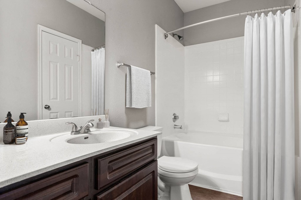 a bathroom with a sink and a toilet and a shower at Veranda at Centerfield, Houston
