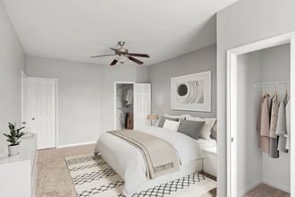 a bedroom with a ceiling fan and a bed at Veranda at Centerfield, Houston