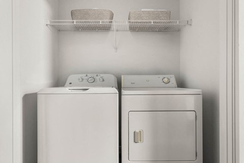 a white washer and dryer in a small laundry room at Veranda at Centerfield, Texas